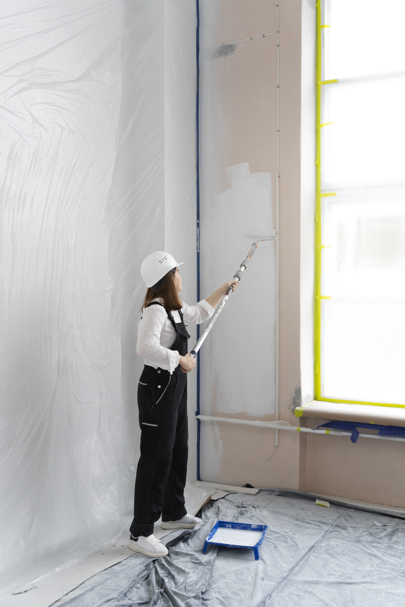 woman working with paint roller full shot